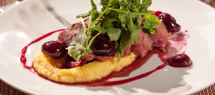 Seared Lamb with Cherry Agrodolce, Creamy Polenta, and Arugula